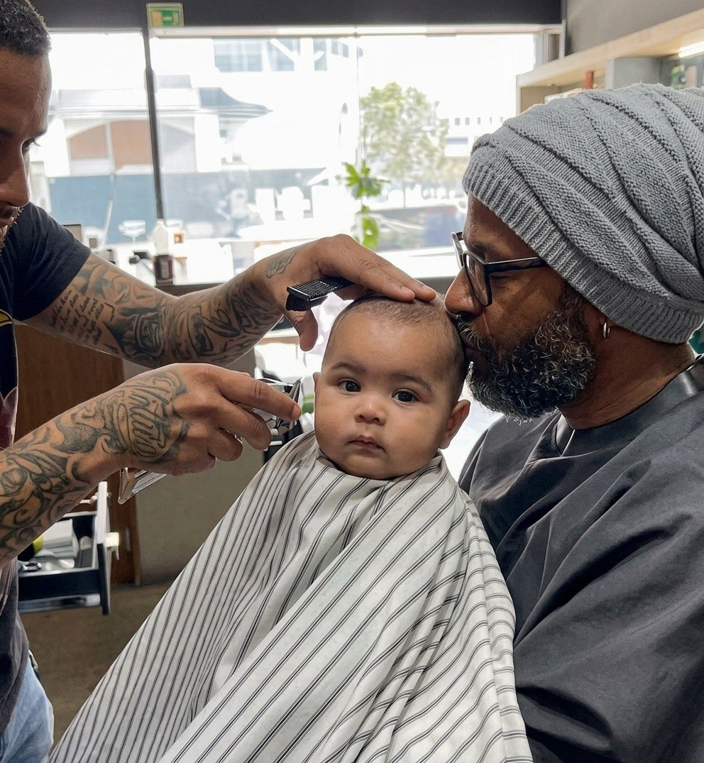 Little baby getting a first haircut and styling in a gentle salon environment
