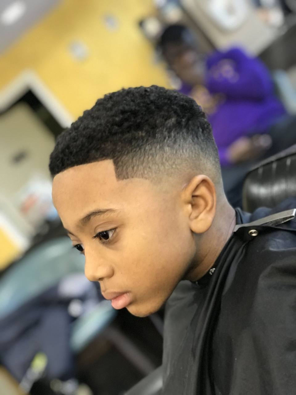 Young client getting a clean, tidy haircut at the salon